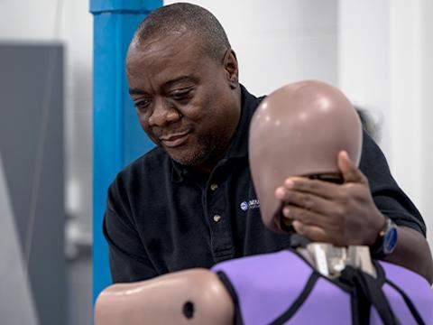 man setting up dummy for test