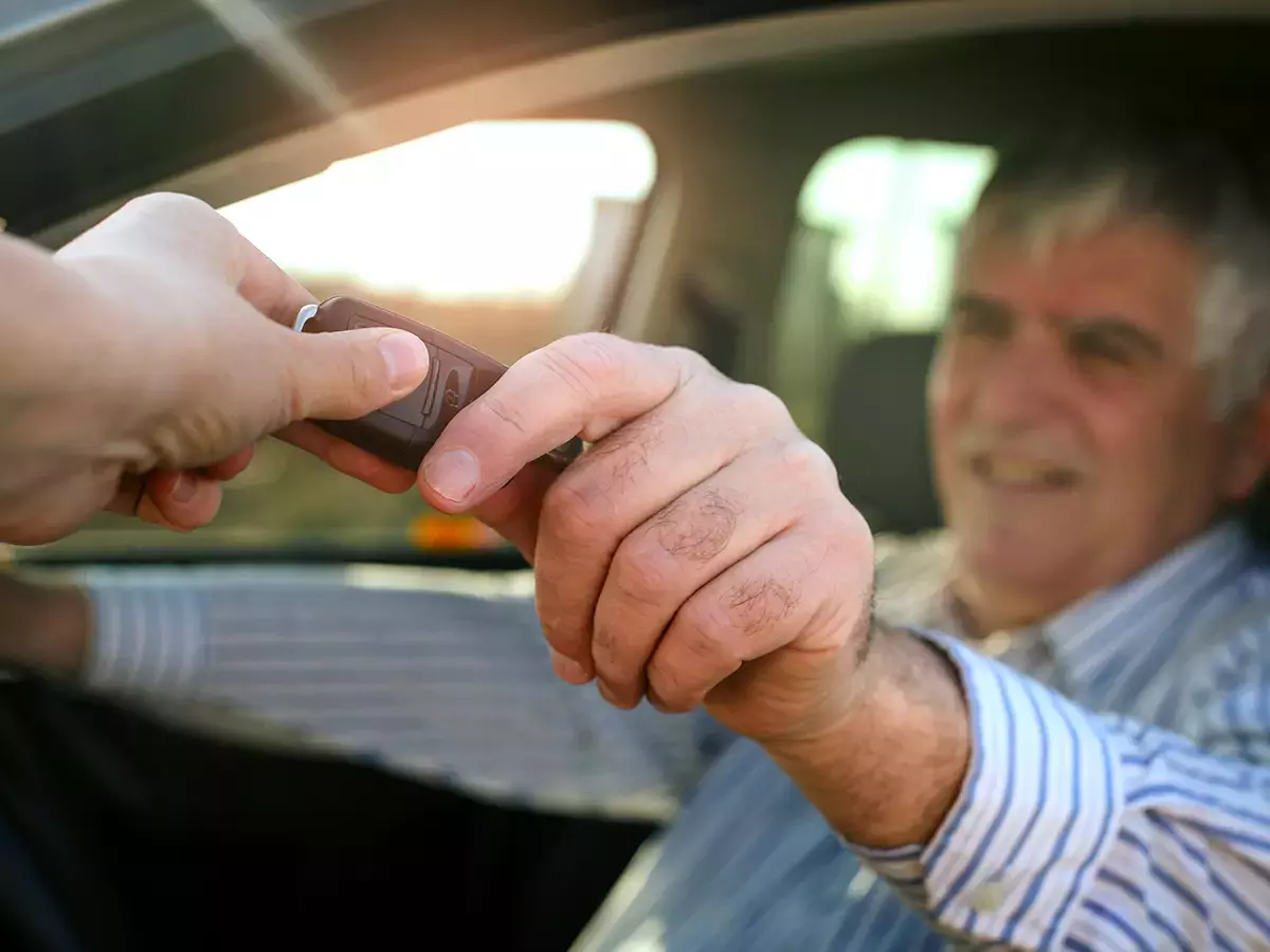 elderly man gets keys to new car
