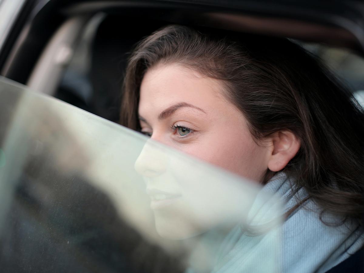 woman looking out of car window